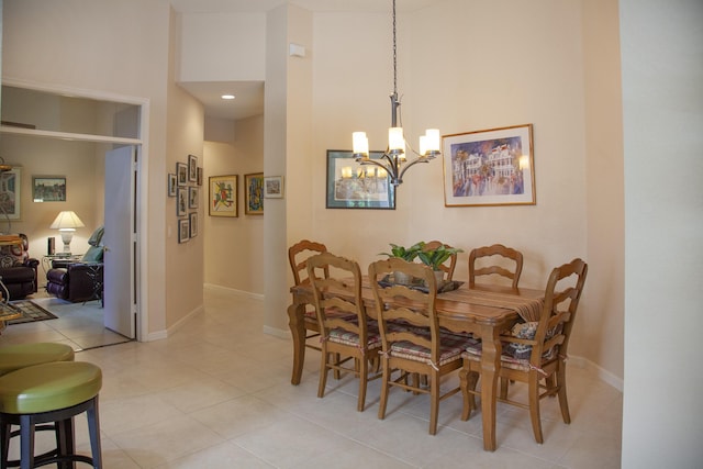 dining room with light tile patterned flooring and an inviting chandelier