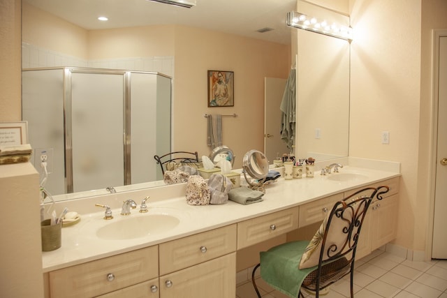 bathroom featuring tile patterned flooring, vanity, and a shower with shower door