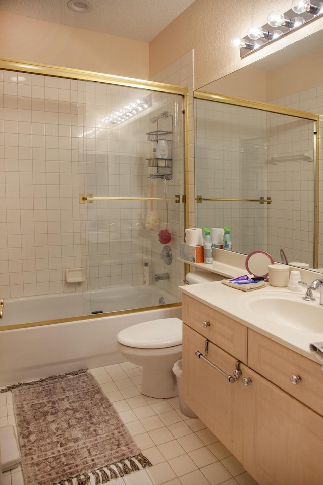 full bathroom featuring tile patterned flooring, vanity, enclosed tub / shower combo, and toilet