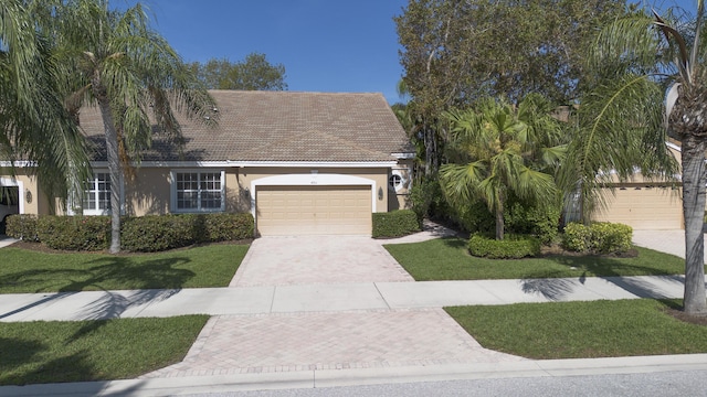 view of front of home with a front yard and a garage