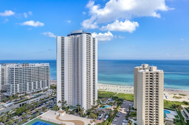 birds eye view of property featuring a water view and a beach view