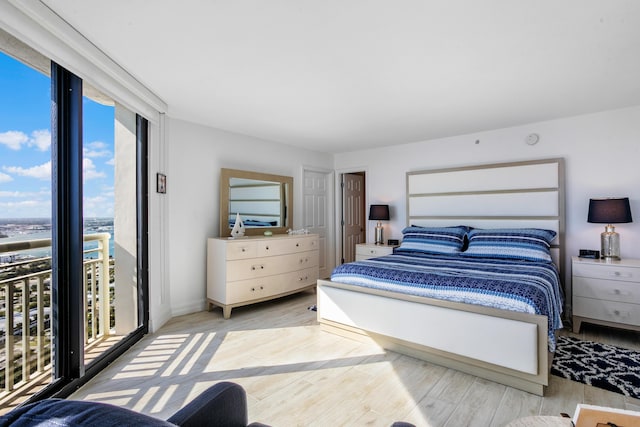 bedroom featuring access to outside and light hardwood / wood-style flooring