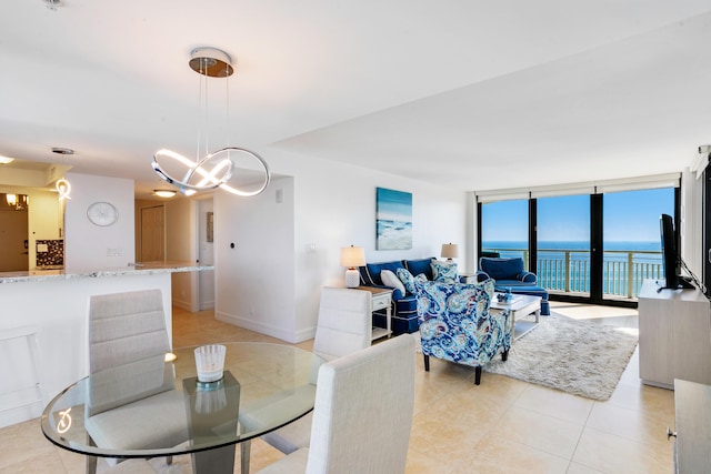 dining space featuring a notable chandelier, floor to ceiling windows, and light tile patterned floors