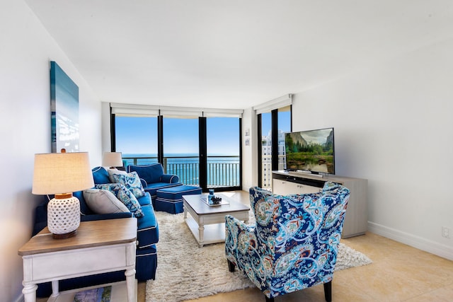 tiled living room featuring a wall of windows