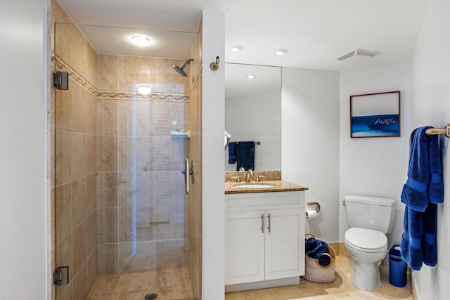 bathroom featuring vanity, toilet, and a shower with door