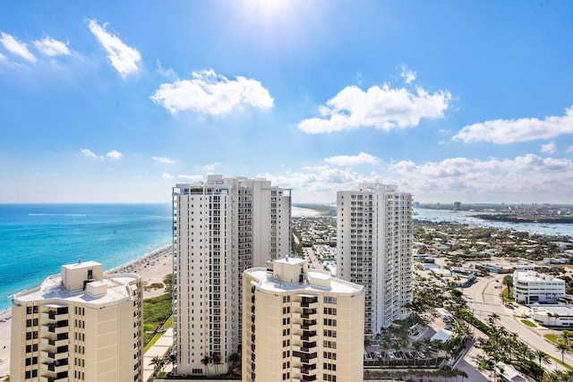 birds eye view of property featuring a water view and a beach view