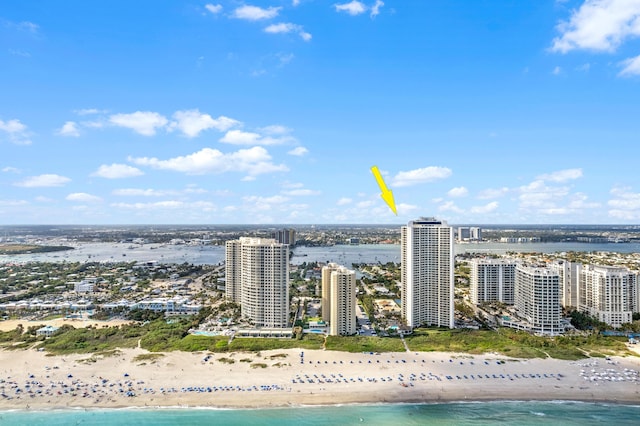 drone / aerial view featuring a water view and a beach view