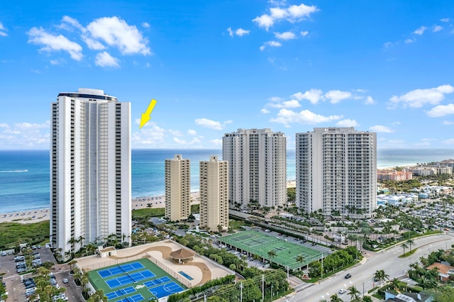 aerial view with a water view and a beach view