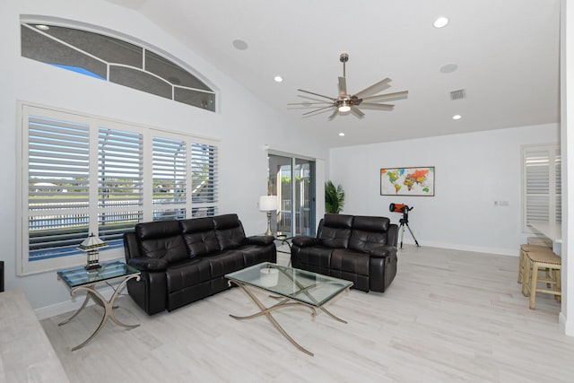 living room with ceiling fan, light hardwood / wood-style floors, and lofted ceiling