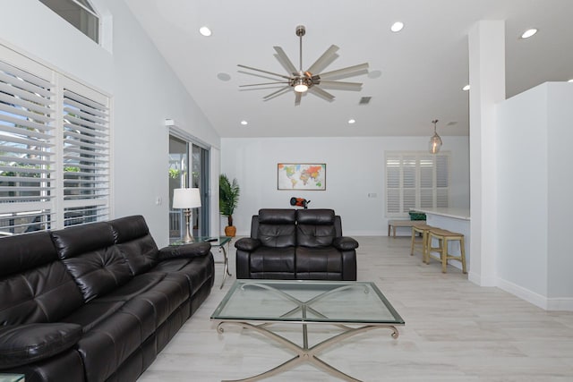 living room featuring ceiling fan and lofted ceiling