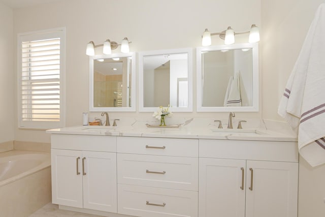 bathroom featuring vanity and a tub to relax in