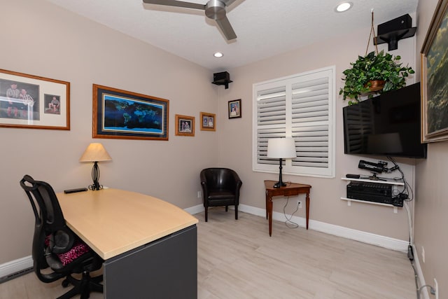 home office featuring ceiling fan, light hardwood / wood-style floors, and a textured ceiling