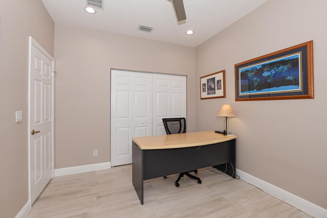 office with a textured ceiling and light wood-type flooring