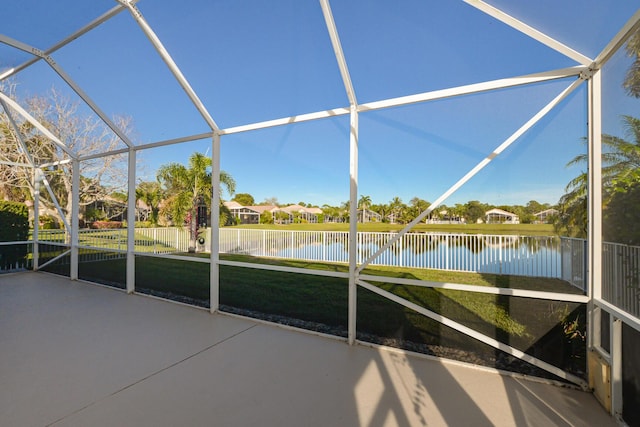 unfurnished sunroom with a water view