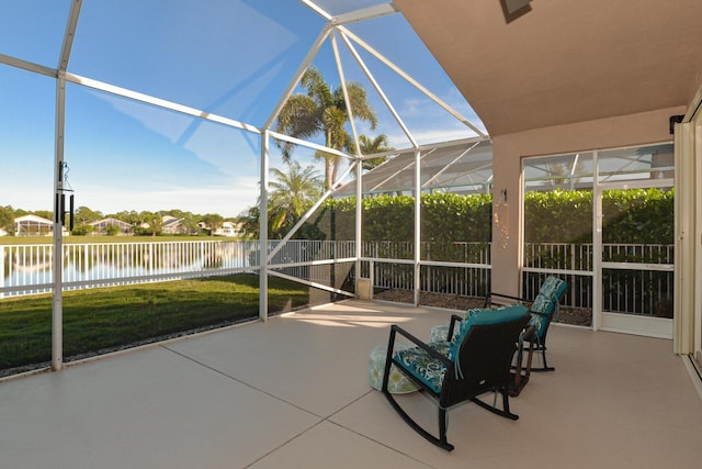 unfurnished sunroom with a water view