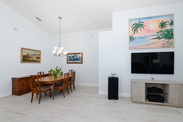 dining room featuring an inviting chandelier and lofted ceiling