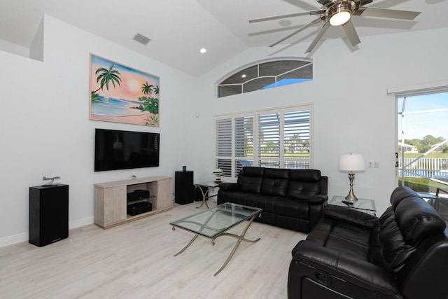 living room with ceiling fan, light wood-type flooring, lofted ceiling, and a wealth of natural light