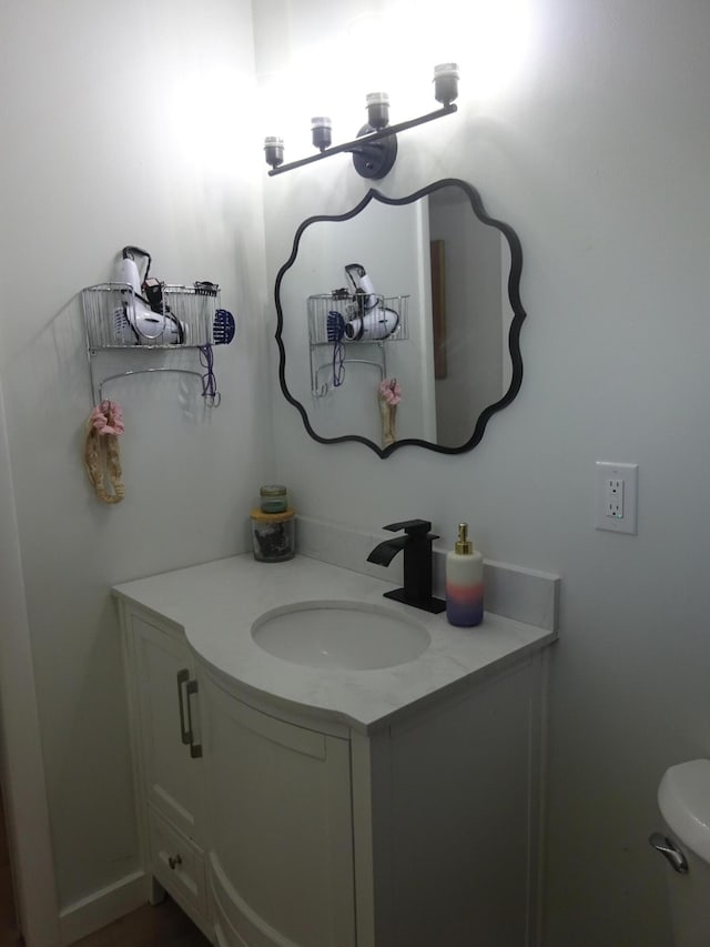 bathroom featuring vanity and toilet