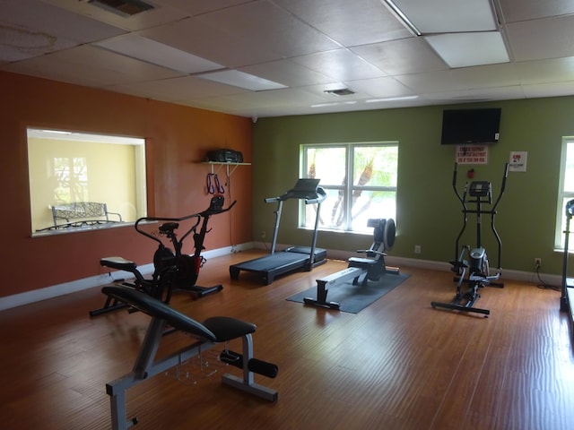 exercise room featuring wood-type flooring and a paneled ceiling