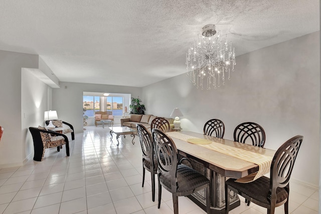 dining room with light tile patterned floors, a chandelier, and a textured ceiling