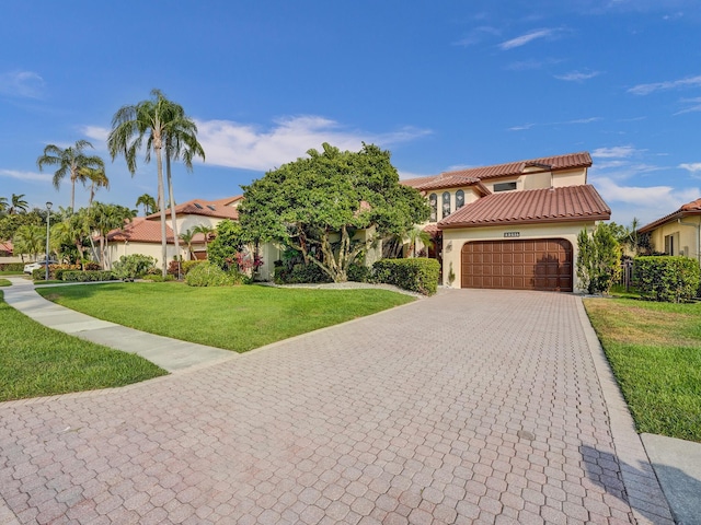 mediterranean / spanish house featuring a front lawn