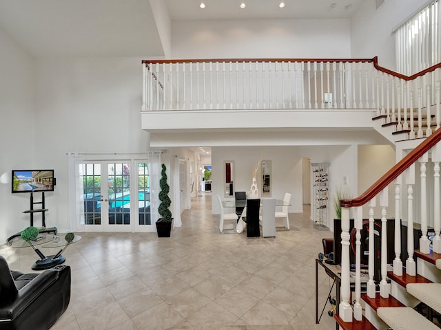 foyer with french doors and a high ceiling