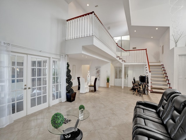 tiled living room with french doors and a high ceiling