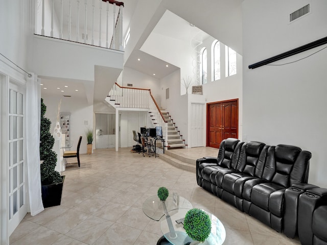 living room featuring a high ceiling and light tile patterned floors