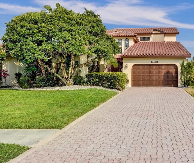 view of front of house featuring a front yard and a garage