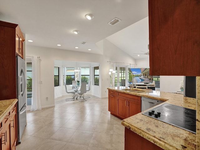 kitchen with lofted ceiling, stainless steel dishwasher, ceiling fan, black electric cooktop, and kitchen peninsula