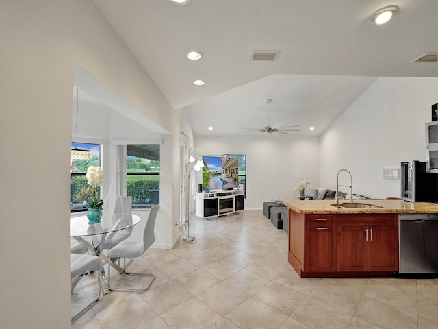 kitchen with light stone counters, stainless steel dishwasher, ceiling fan, sink, and lofted ceiling