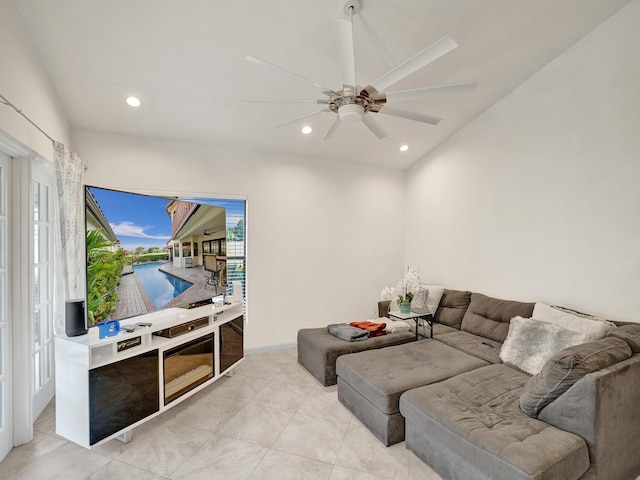 living room featuring light tile patterned floors and ceiling fan