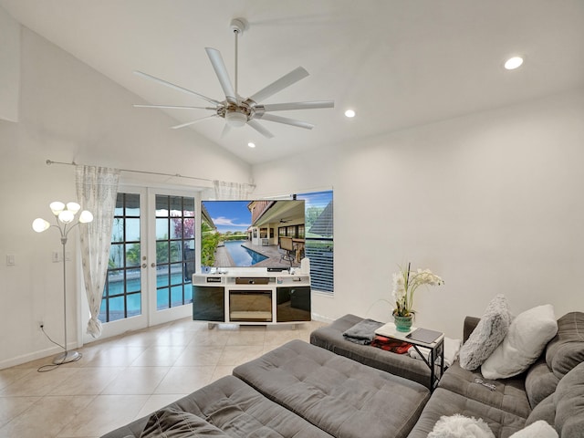 living room with ceiling fan, lofted ceiling, light tile patterned floors, and french doors