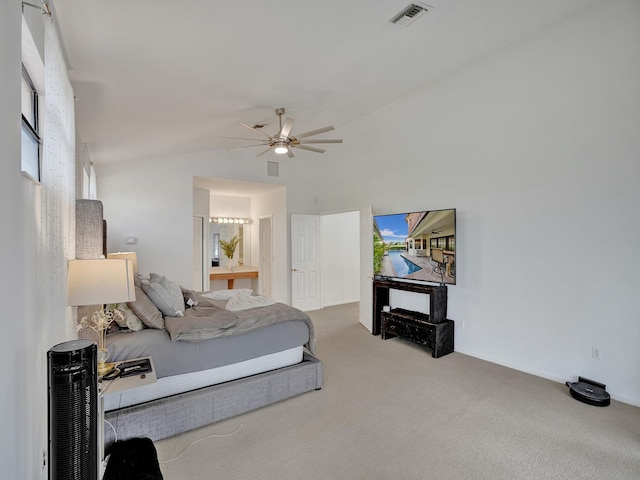 bedroom with carpet flooring, ensuite bathroom, vaulted ceiling, and ceiling fan