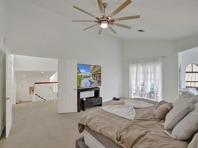 carpeted bedroom with high vaulted ceiling and ceiling fan