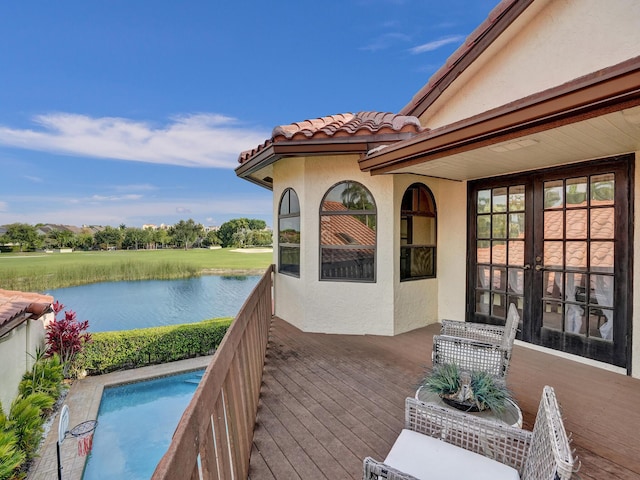 wooden deck featuring a water view