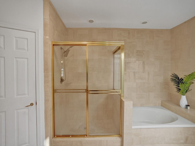 bathroom featuring shower with separate bathtub