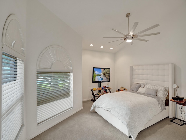 bedroom featuring light carpet, vaulted ceiling, and ceiling fan