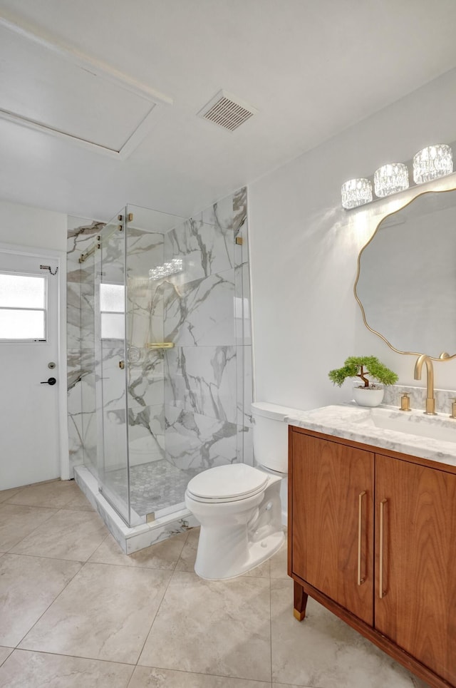 bathroom with vanity, toilet, and a shower with shower door