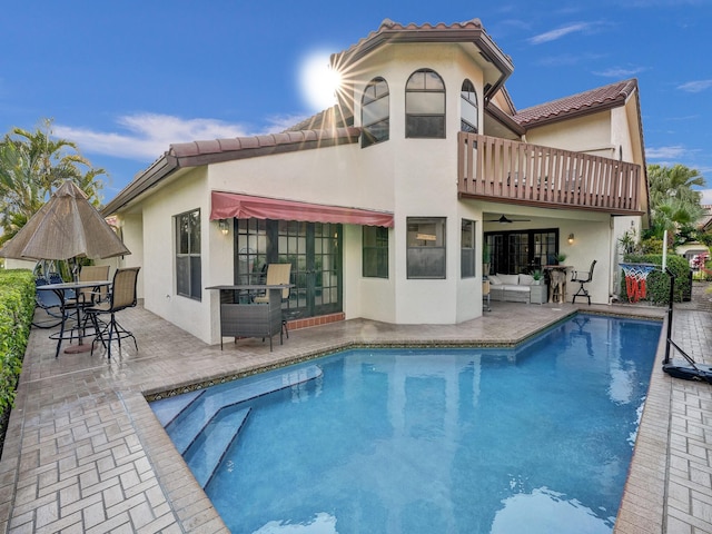 back of house with a patio area and a balcony