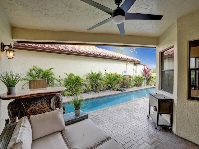 view of pool featuring ceiling fan and a patio