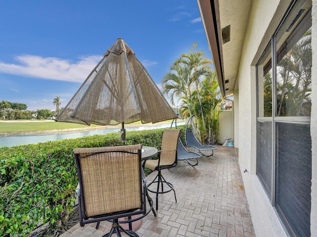 view of patio with a water view