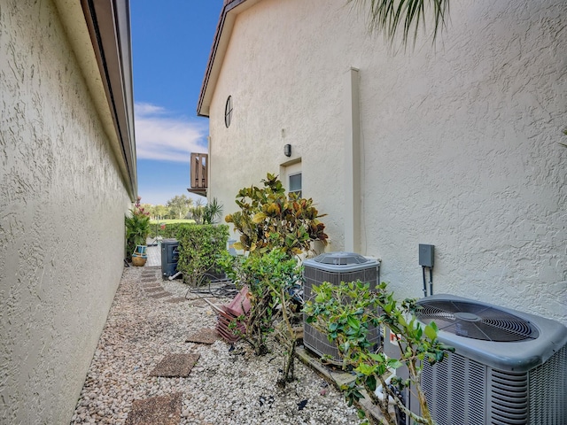 view of side of home featuring central AC