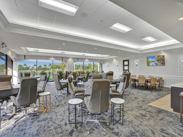 carpeted dining room with plenty of natural light, a raised ceiling, and crown molding