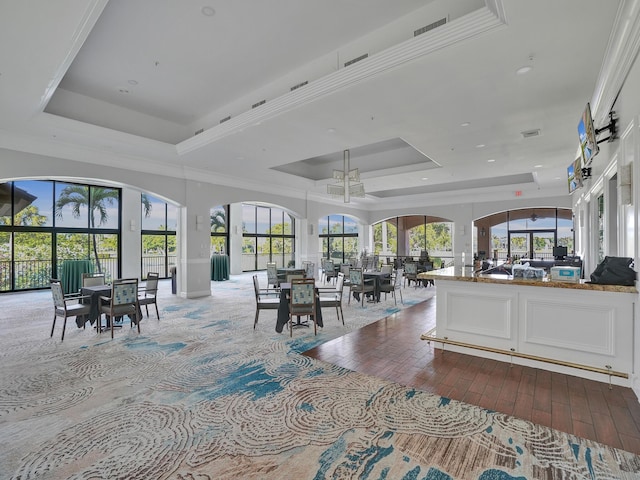 interior space with a tray ceiling and ornamental molding