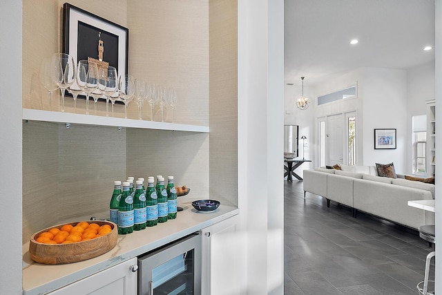 bar featuring pendant lighting and beverage cooler