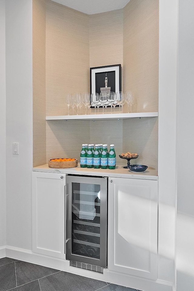 bar with dark tile patterned flooring, decorative backsplash, and wine cooler