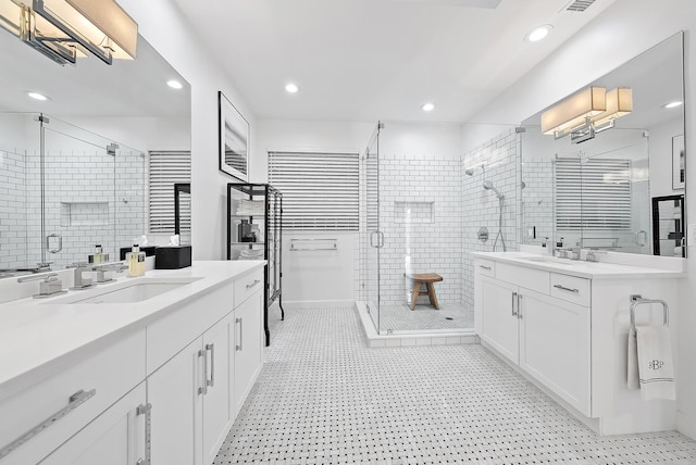 bathroom featuring vanity and a shower with door