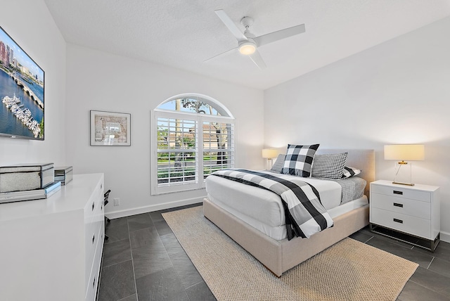 bedroom with a textured ceiling and ceiling fan