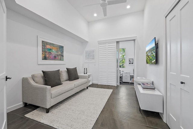 tiled living room featuring ceiling fan